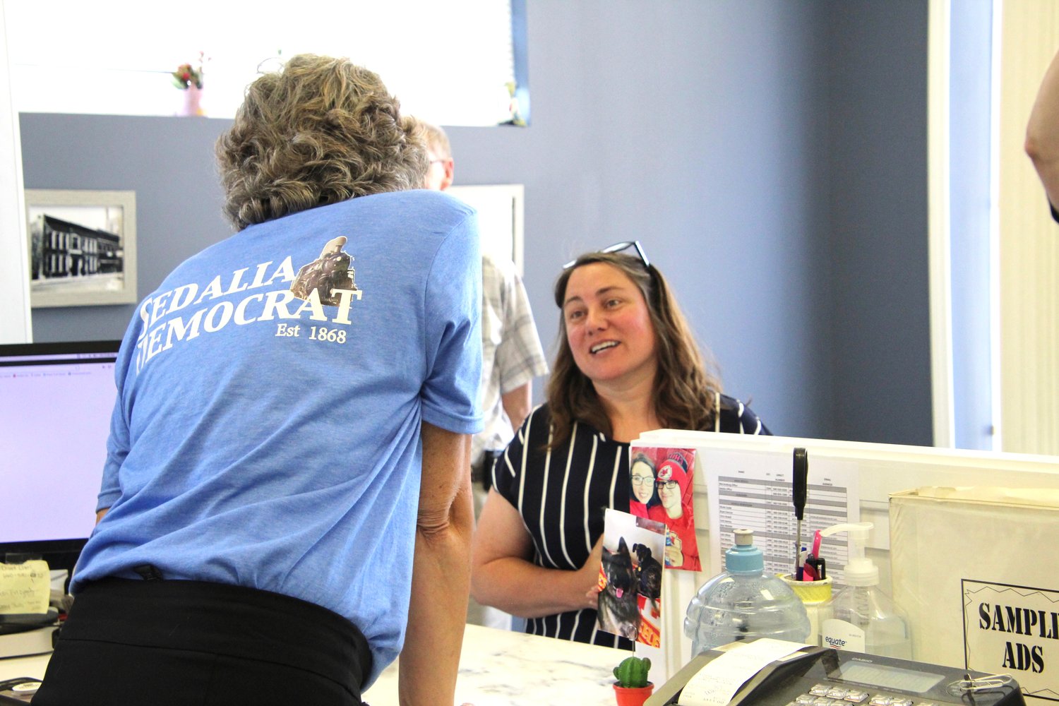 Democrat sales representative Diana Surface speaks with RE/MAX of Sedalia realtor Billie Barnes during the open house.
